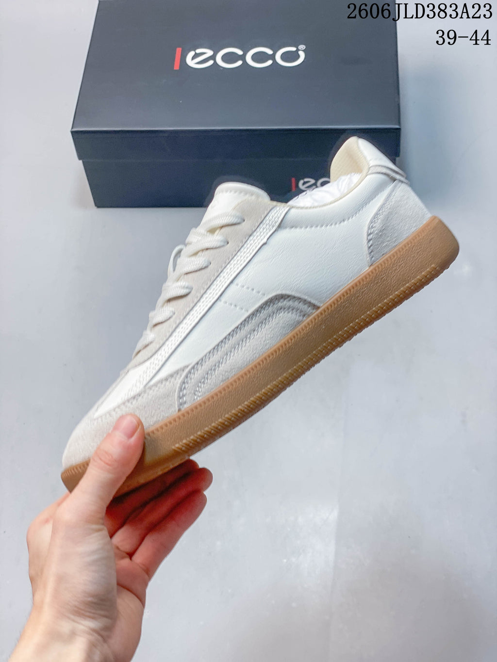 Side view of the off-white low-top sneaker with textured overlays and a gum-colored sole; image overlay shows sizes 39–44 and code 2606 JLD383A23.