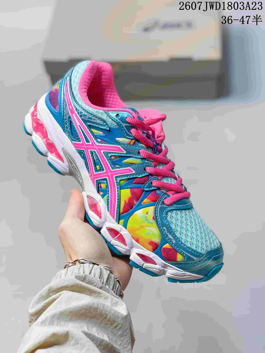 Blue, pink and multicolor ASICS Gel-Nimbus 16 sneaker with a contrasting sole.