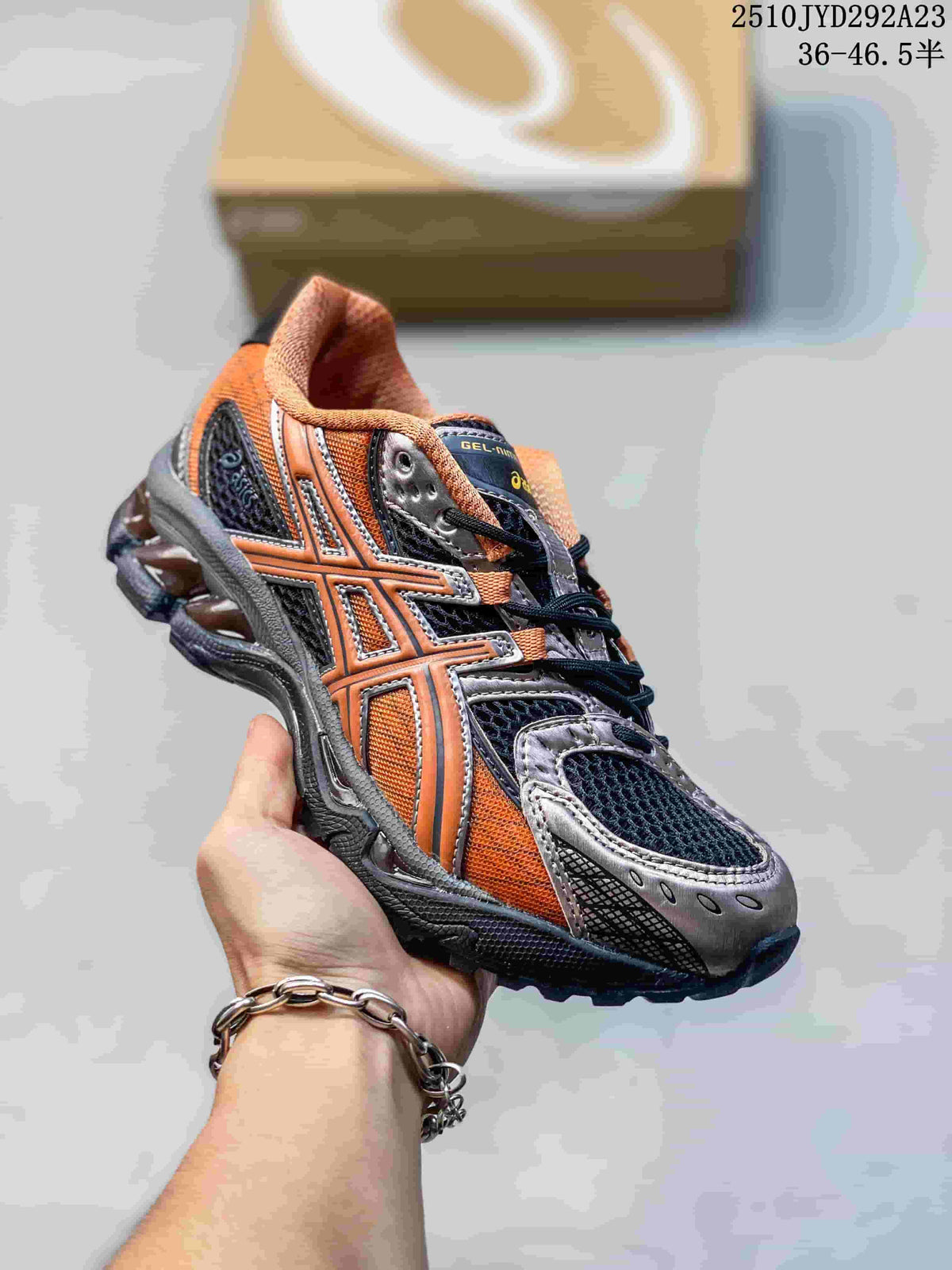 Close-up of an orange, dark navy, and gray sneaker with layered side stripes.