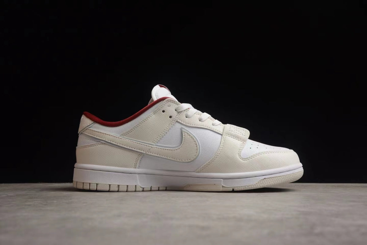 Side profile showing the low-top silhouette, off-white overlays, white side panel, and red collar lining.
