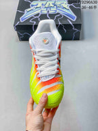 Front view of a Nike Ja 3 basketball shoe with white laces and a neon yellow, orange, and white upper.
