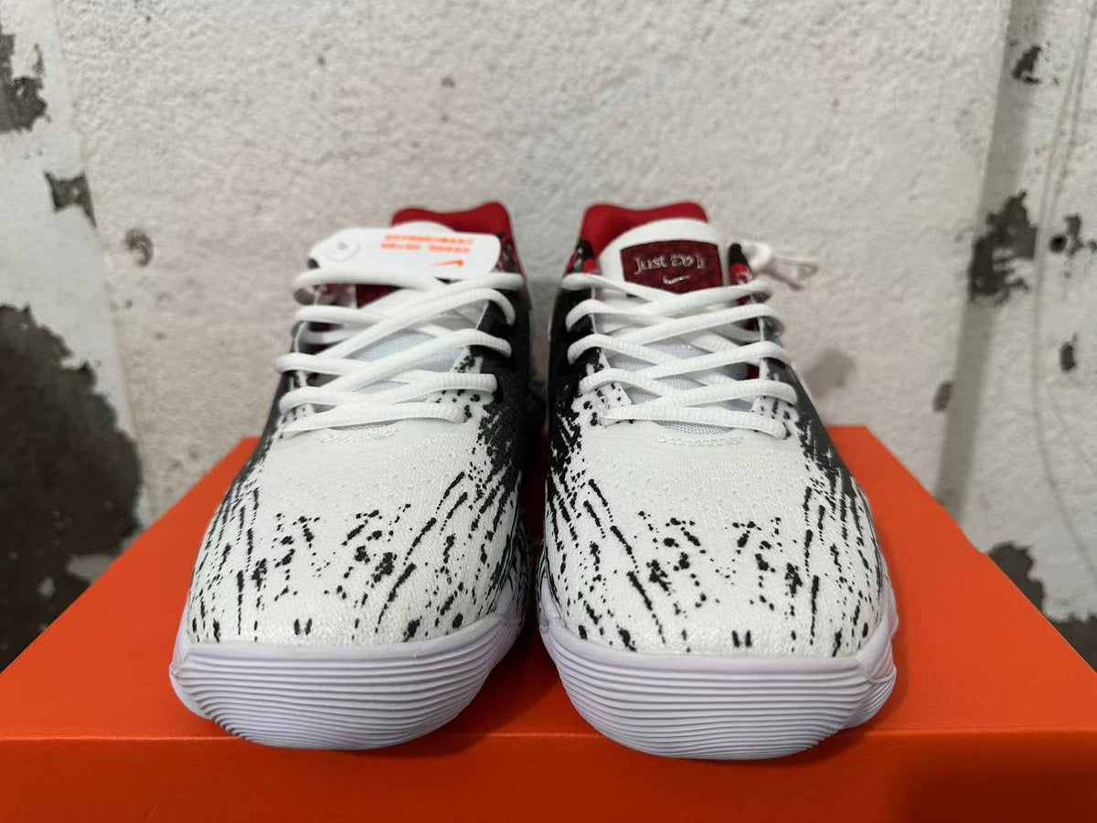 Front view of black, white, and red Nike shoes with white laces