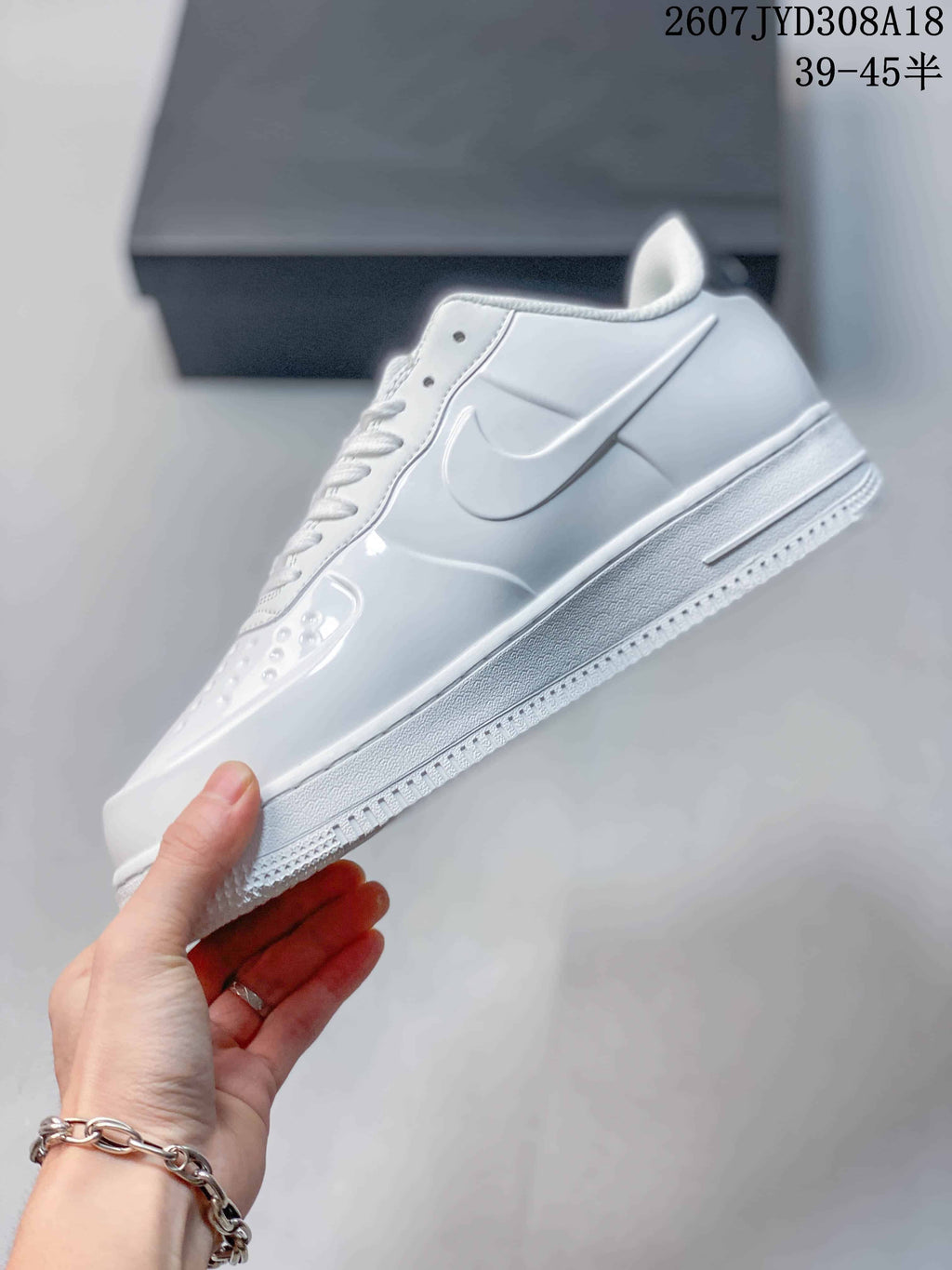 Side profile highlighting the white layered upper, Swoosh logo, raised midsole and textured outsole.