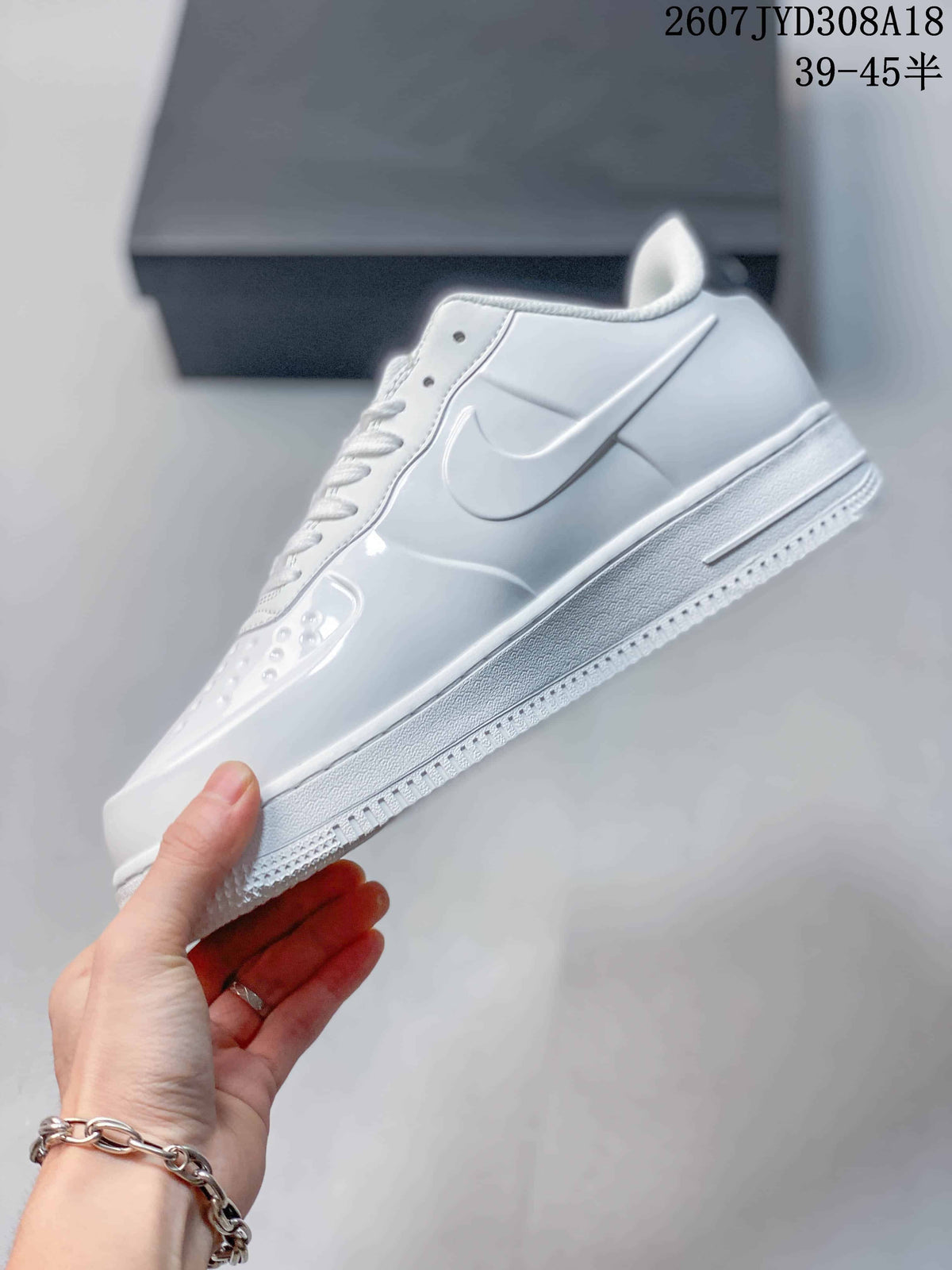 Side profile highlighting the white layered upper, Swoosh logo, raised midsole and textured outsole.