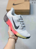 White Nike ReactX Pegasus ACG Trail 6 sneaker with a bright coral and yellow gradient midsole area.