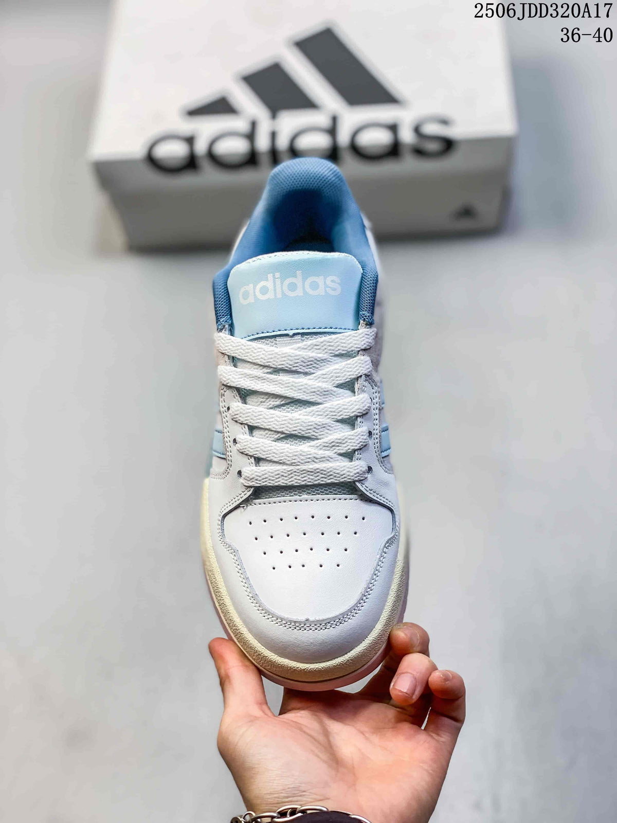 Top view of the sneaker showing white laces, a perforated toe box, blue tongue and adidas branding.