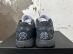 Rear view of a pair of black and purple Kobe 6 basketball shoes with speckled midsoles