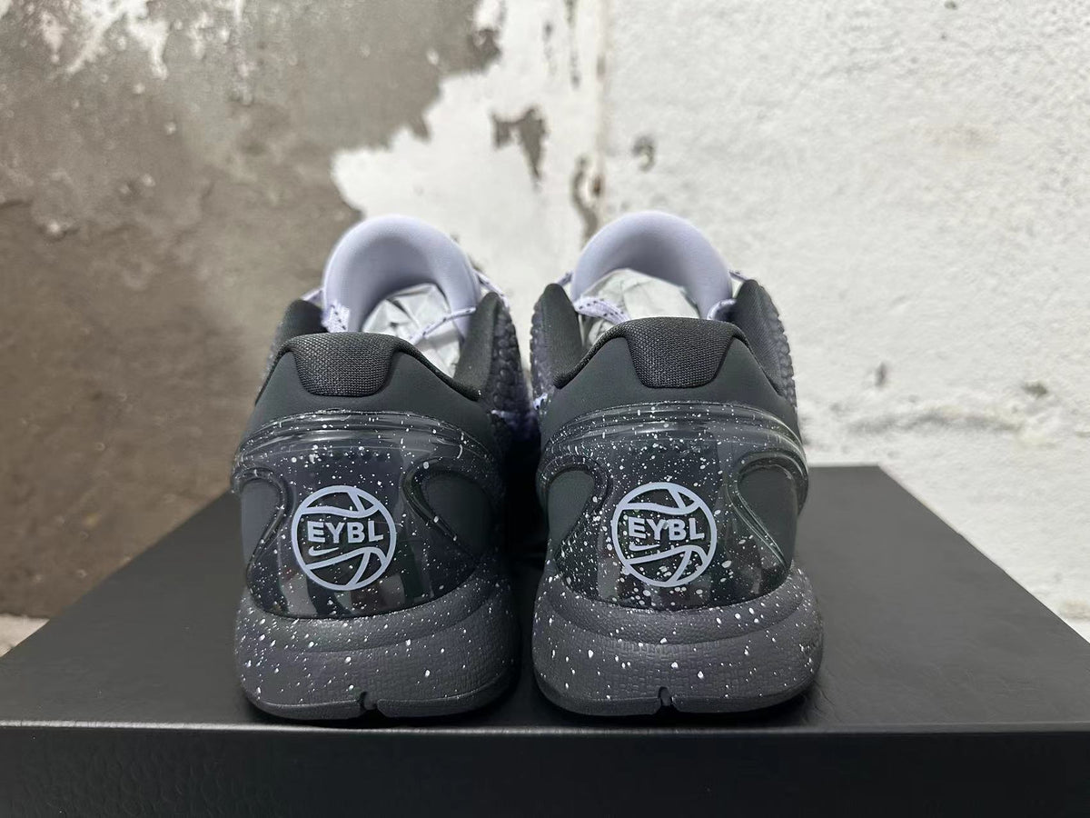 Rear view of a pair of black and purple Kobe 6 basketball shoes with speckled midsoles