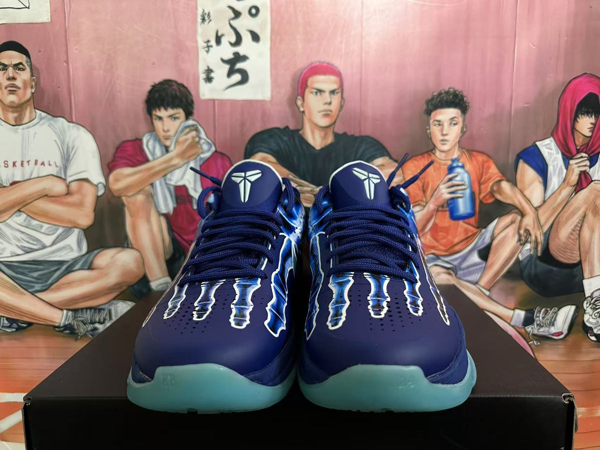 Front view of navy and blue Kobe basketball shoes with graphic overlays and aqua-colored soles