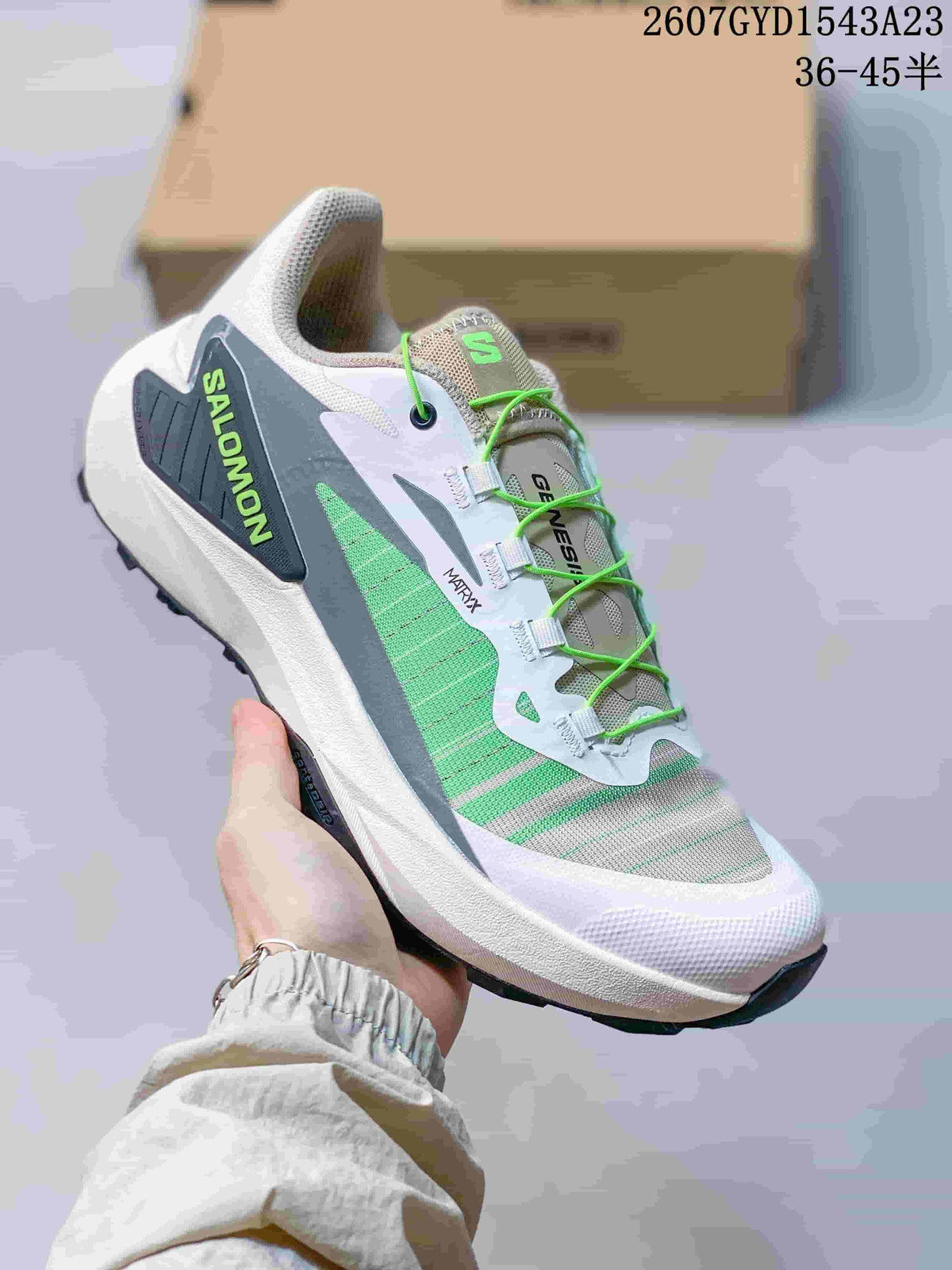 White, gray and green Salomon Genesis shoe with bright green laces and a contrasting outsole.