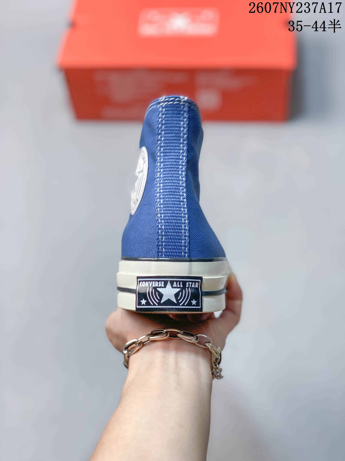 Rear view of the blue high-top sneaker showing the Converse All Star heel label.