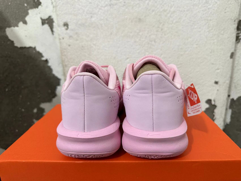 Rear view of pink Nike Precision 7 basketball shoes on an orange box