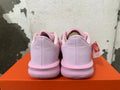 Rear view of pink Nike Precision 7 basketball shoes on an orange box