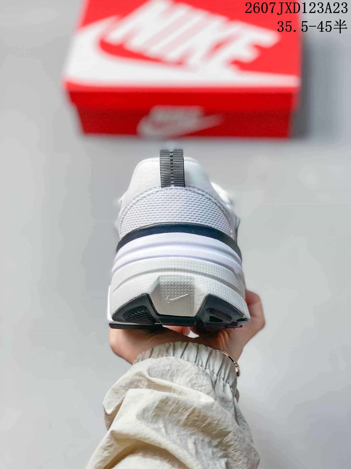 Rear view showing the padded heel collar, pull tab, layered midsole, and outsole.