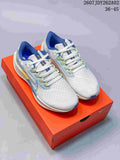 Pair of Nike Pegasus 38 shoes in off-white, pale blue and green, shown on an orange shoe box.