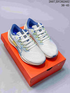 Pair of Nike Pegasus 38 shoes in off-white, pale blue and green, shown on an orange shoe box.