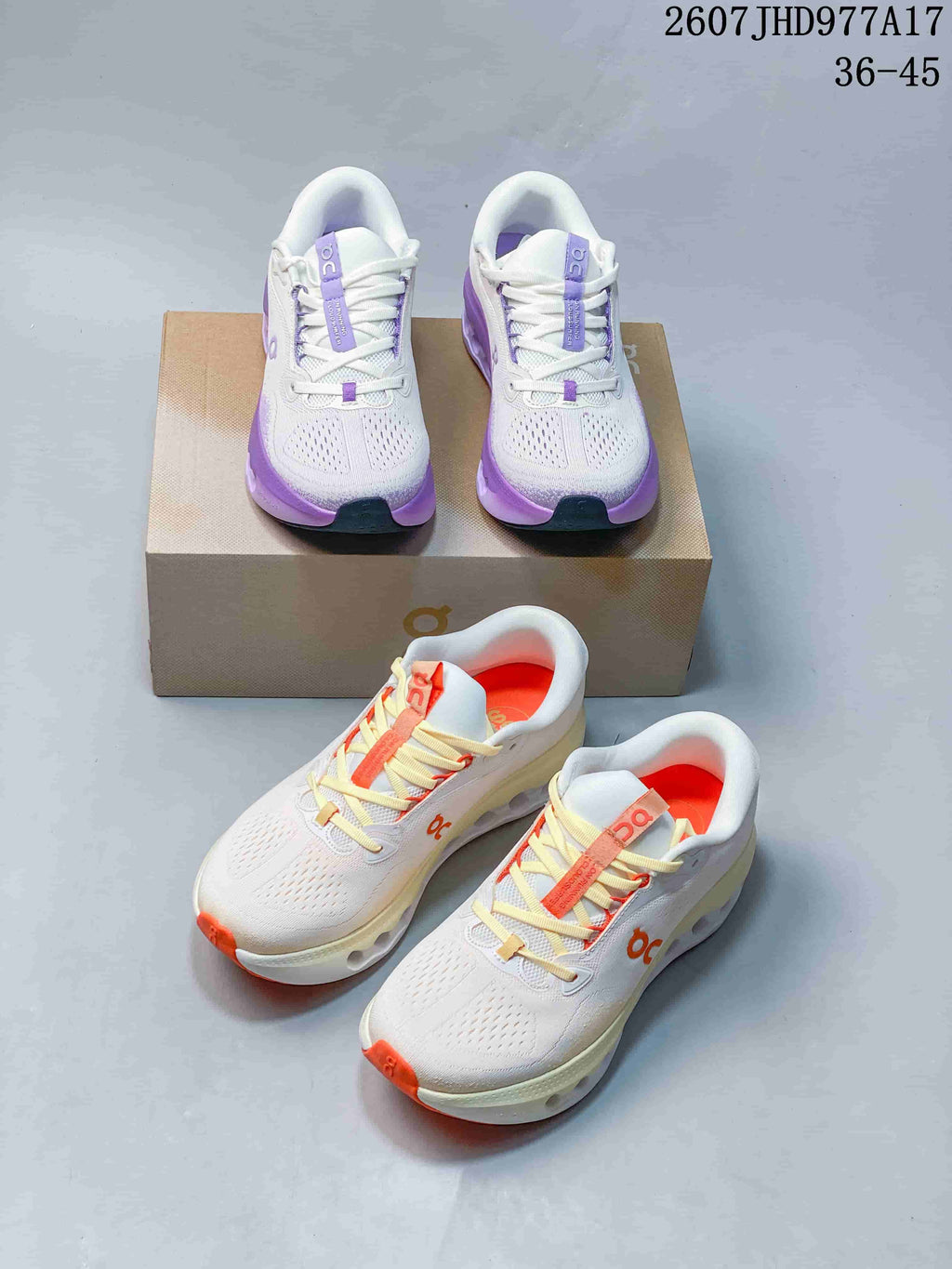 Both white On Cloudtilt colorways shown together, including purple-accented and orange-accented pairs.