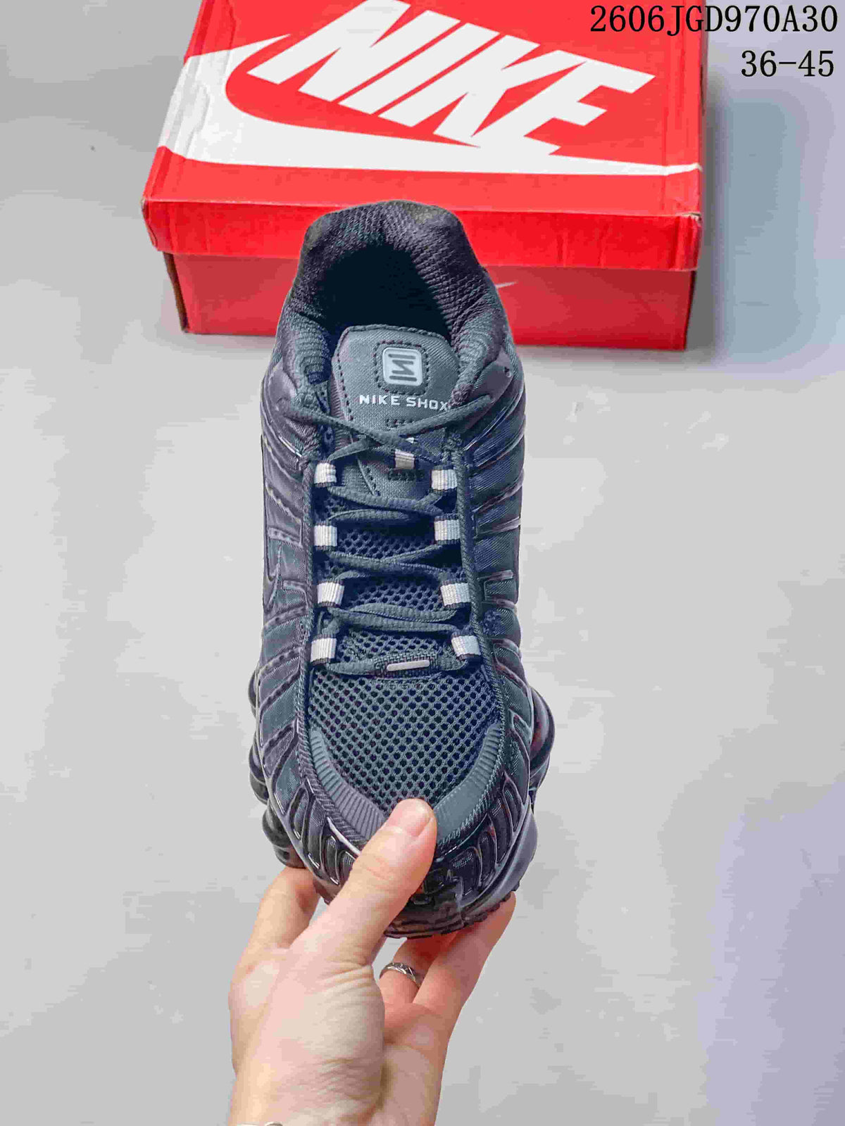 Top view showing the mesh toe, laces, and tongue of a dark Nike Shox TL sneaker