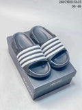 Pair of dark ECCO slide sandals with four white bands displayed on a branded box; image text shows style code 2607ND515A25 and sizes 36–46.