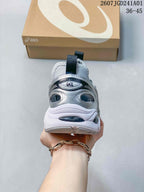 Rear view of a silver-toned ASICS GT-2160 Breeze sneaker showing the heel and pull tab.