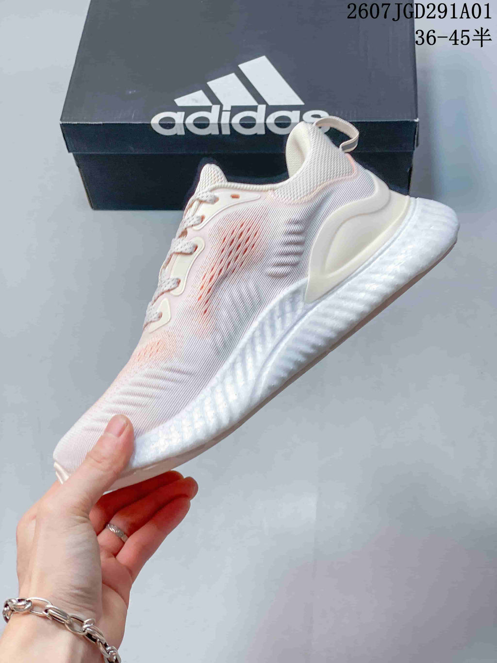 Side view of the low-top sneakers with pale pink accents
