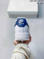 Rear view of the sneaker showing the blue heel tab, white upper and layered white sole.