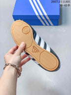 Underside of the sneaker showing a gum-colored outsole with textured tread