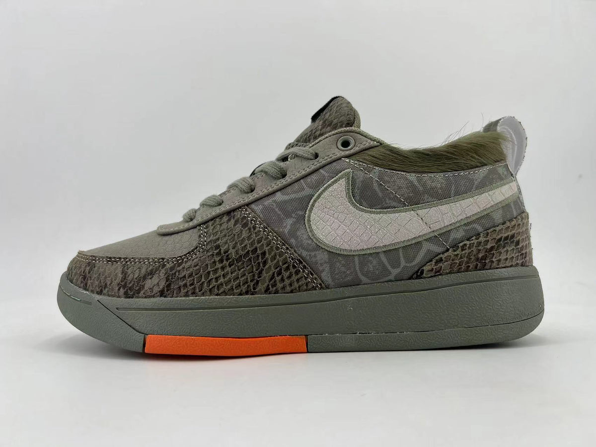 Opposite side profile of the sneakers with textured panels and orange sole detail