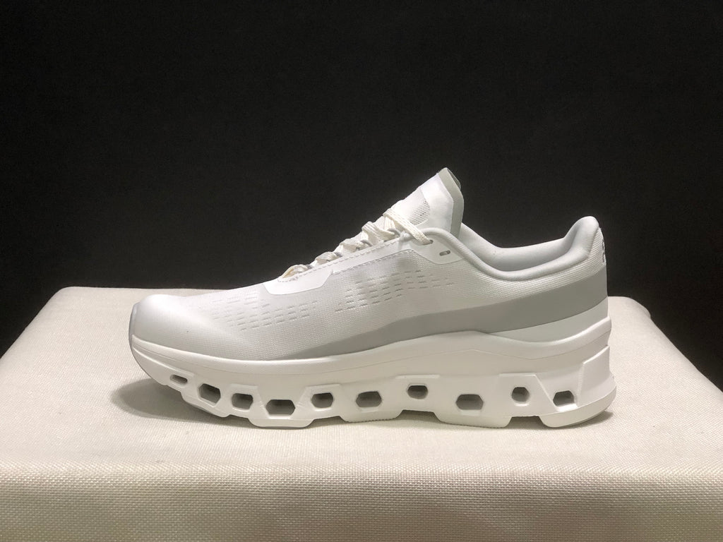 Side profile showing the white upper, padded collar, and sculpted sole.