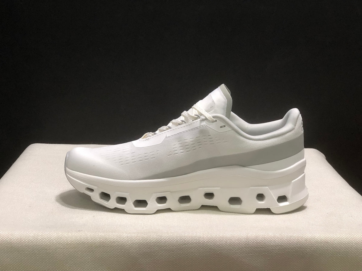 Side profile showing the white upper, padded collar, and sculpted sole.
