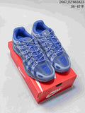 Pair of blue and gray Nike P-6000 sneakers displayed on a red shoebox