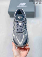 Front view showing the mesh toe box, grey overlays, navy accents, and laces.