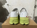 Rear view of gray On running shoes with lime-green soles