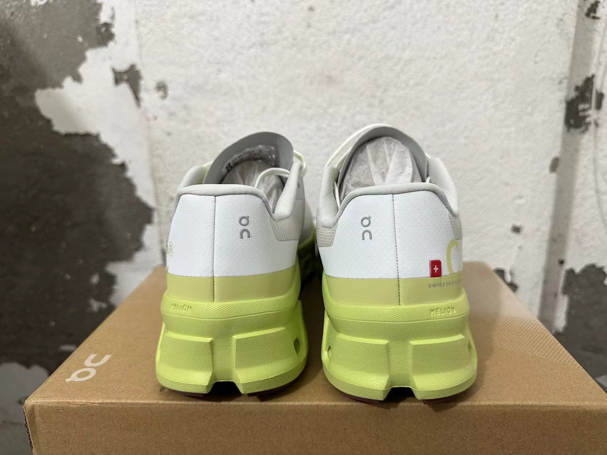Rear view of gray On running shoes with lime-green soles