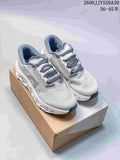 Pair of light gray On Cloudmonster 3 running shoes on a shoebox