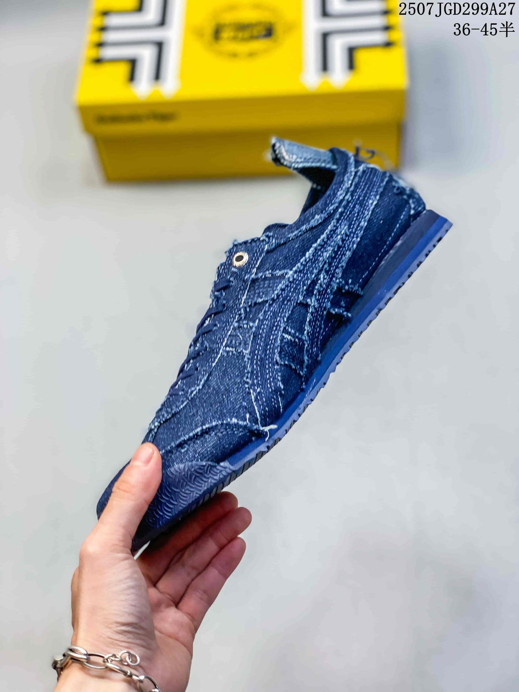 Side profile of the blue lace-up sneaker showing its low-top shape, side stripes and textured outsole.