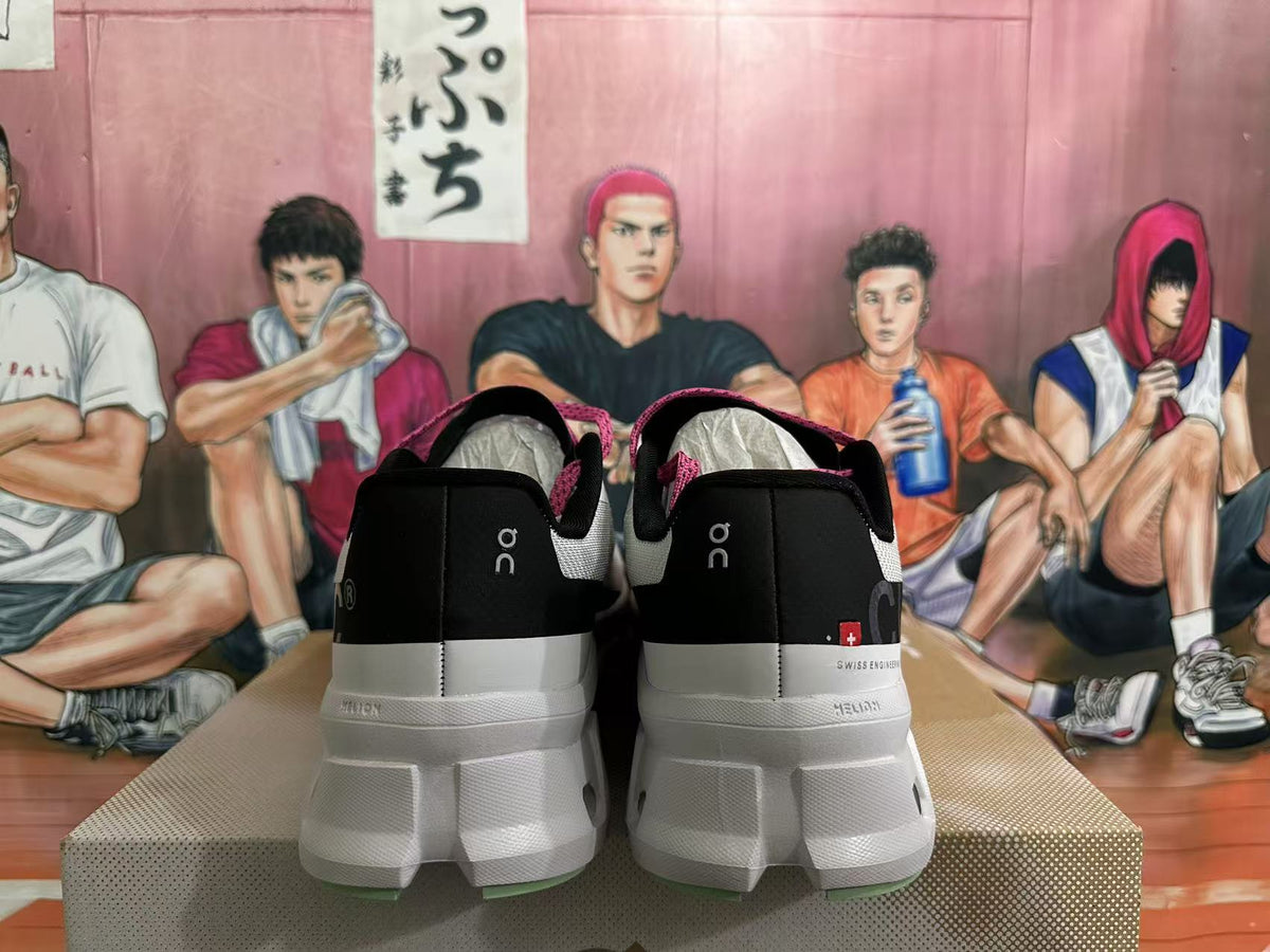 Rear view of grey-white and black sneakers with pink lining and pale green outsole details.