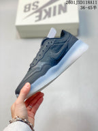 Side view of a dark gray Nike SB low-top shoe showing the layered upper, side Swoosh, and translucent outsole.