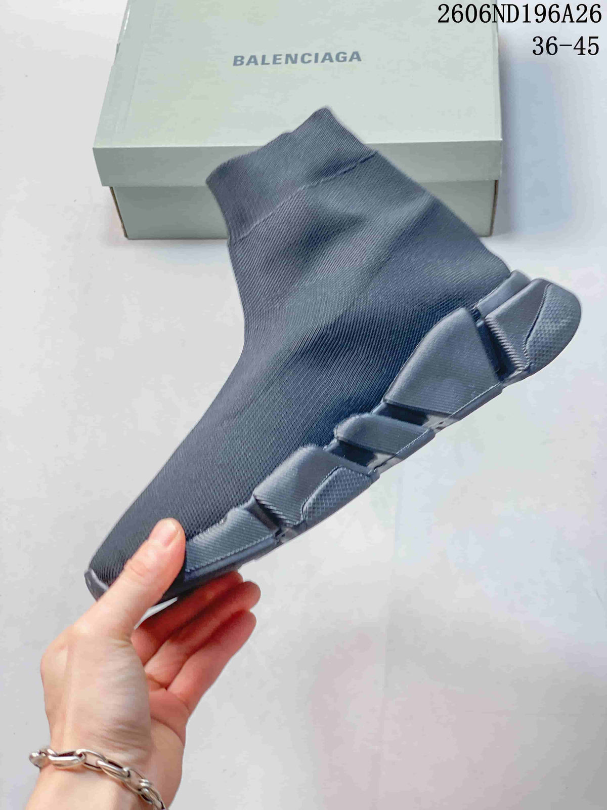 Side view of the dark gray sneaker highlighting the sock-style upper and segmented outsole.