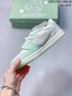 Side view of the mint green and white sneaker showing the side swoosh-style detail and layered panels.