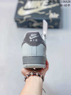 Rear view showing the padded collar, Nike Air heel branding, gray heel panel, and layered outsole.