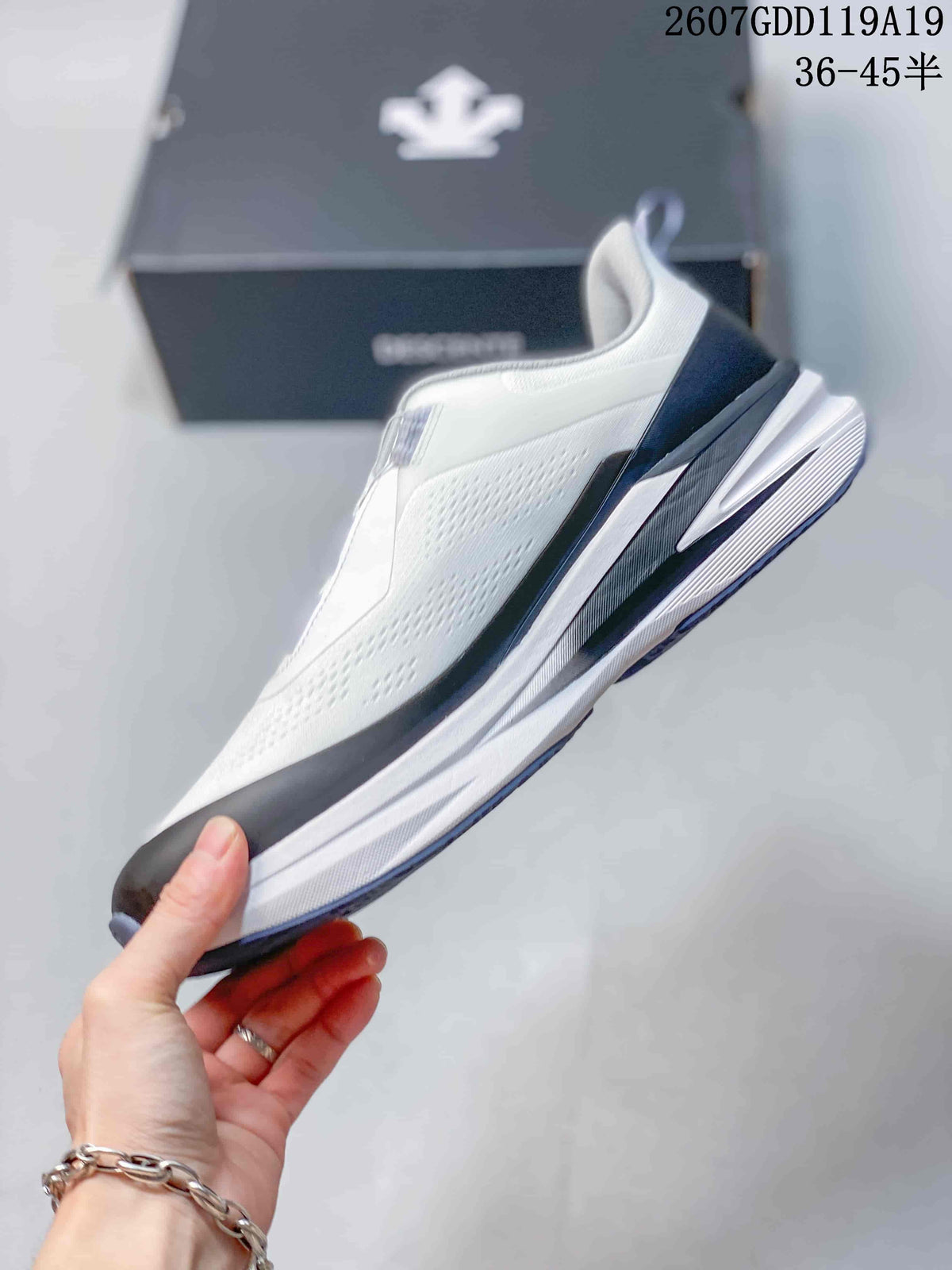 Side profile of the white low-top running shoe showing the textured upper, dark overlays, and layered midsole.