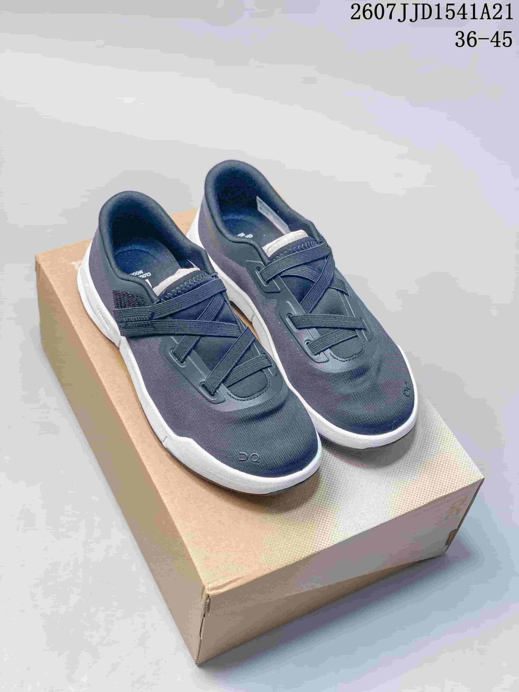 Pair of dark navy On Cloudnova sneakers displayed on a cardboard shoebox; model code and EU size range appear at the top.