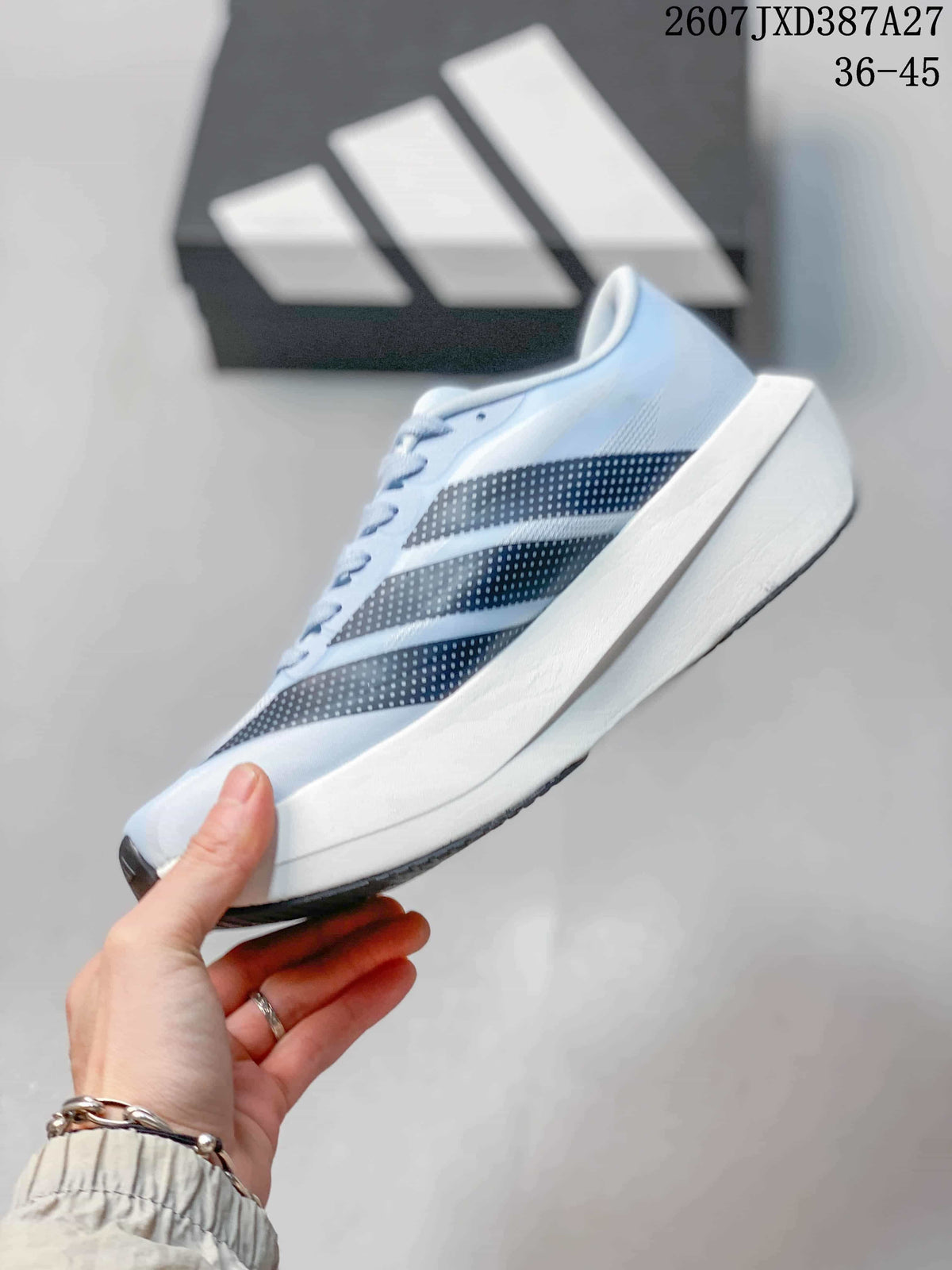 Side profile of the light blue running shoe showing the dotted adidas stripes and raised white midsole.