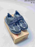 Pair of dark navy and gray New Balance Breeze sneakers displayed on a branded shoebox.