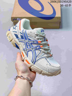 Angled side view of the white ASICS sneaker with blue overlays, orange accents, and a rugged outsole.