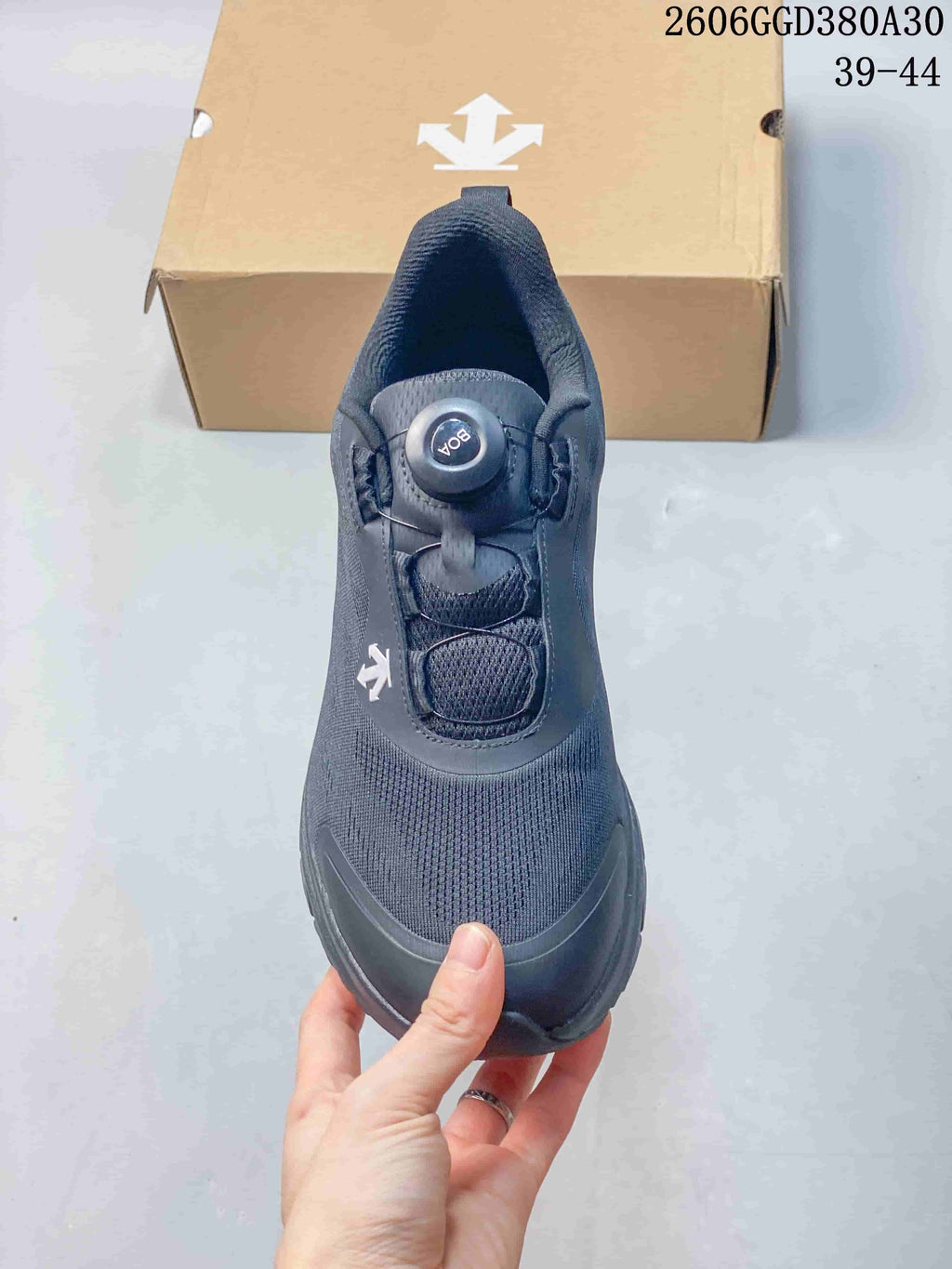 Top view of a dark gray shoe showing its dial closure and textured upper