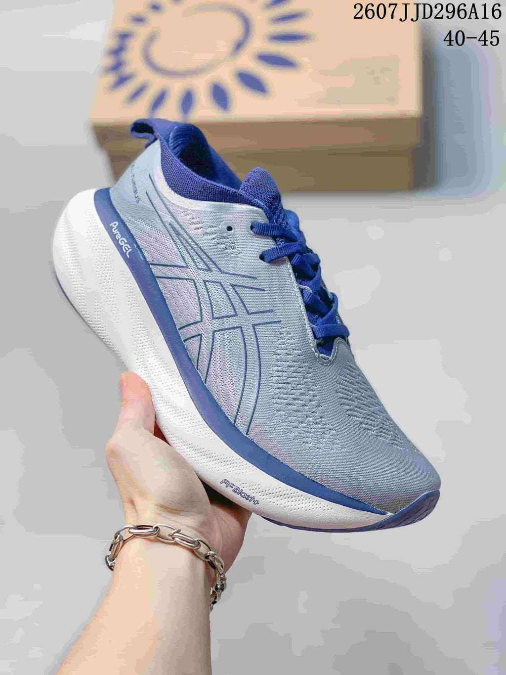 Side profile of the gray and blue ASICS sneaker with visible PureGEL and FF BLAST+ markings.