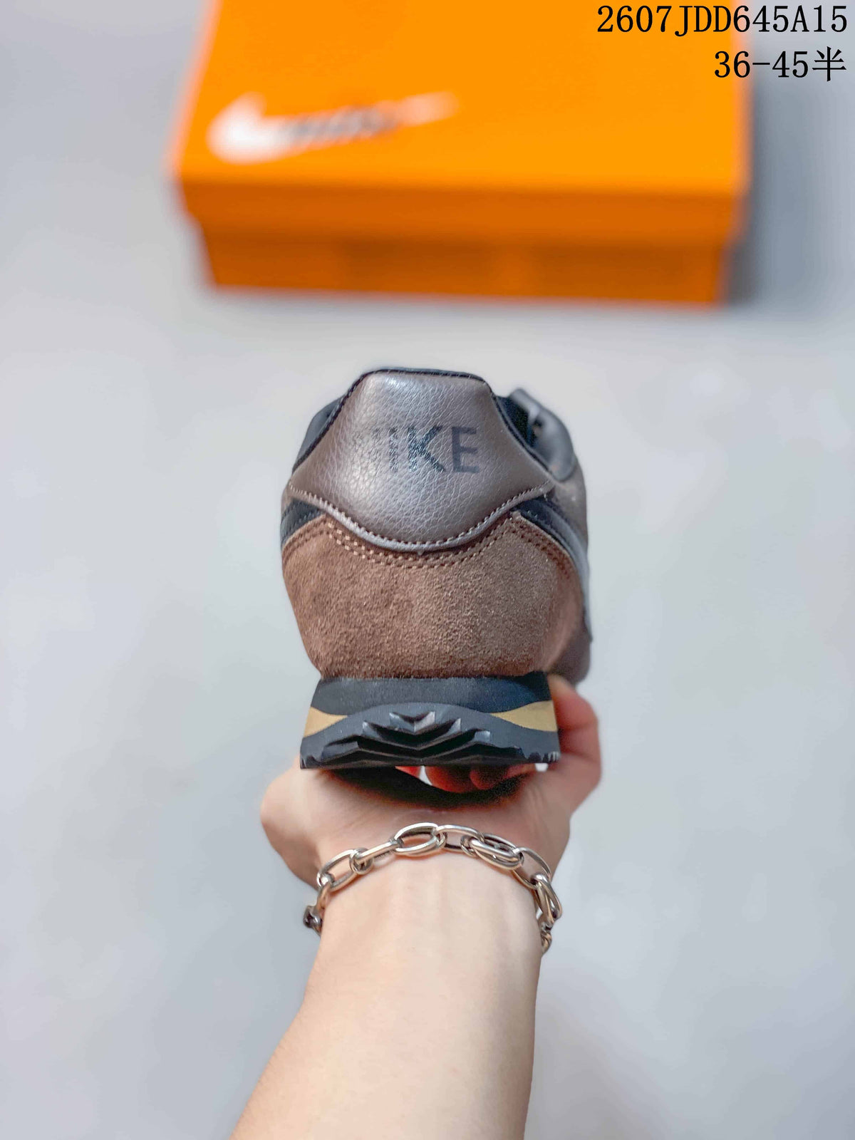 Rear view of the brown and black sneaker showing the padded heel collar and layered outsole.