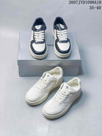 White and navy and all-white SMFK sneaker pairs shown together from the front and side.